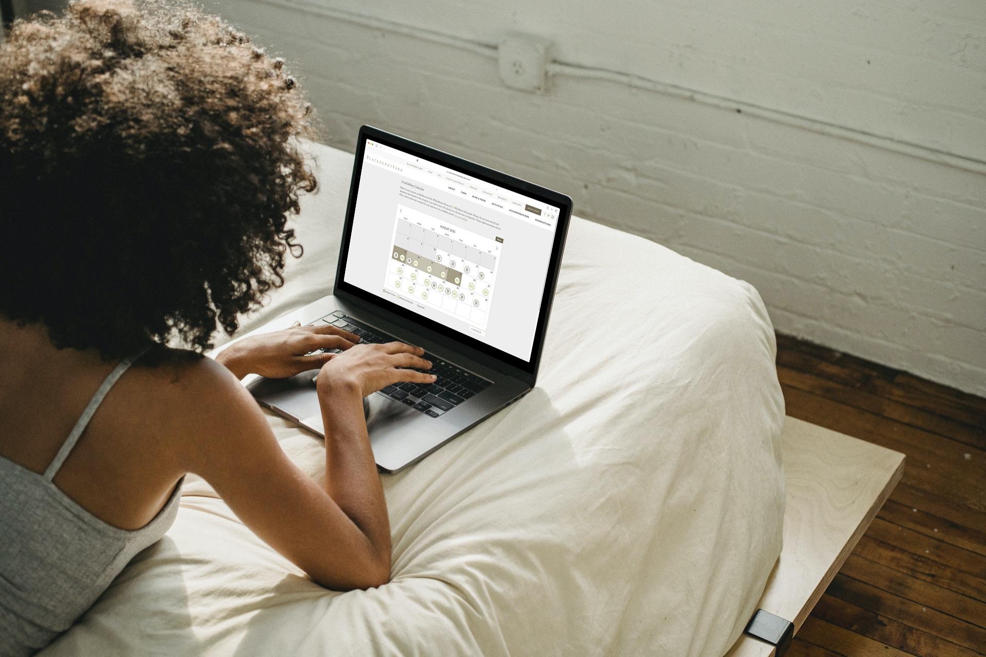 A person using the Blackberry Farm reservation website on a laptop