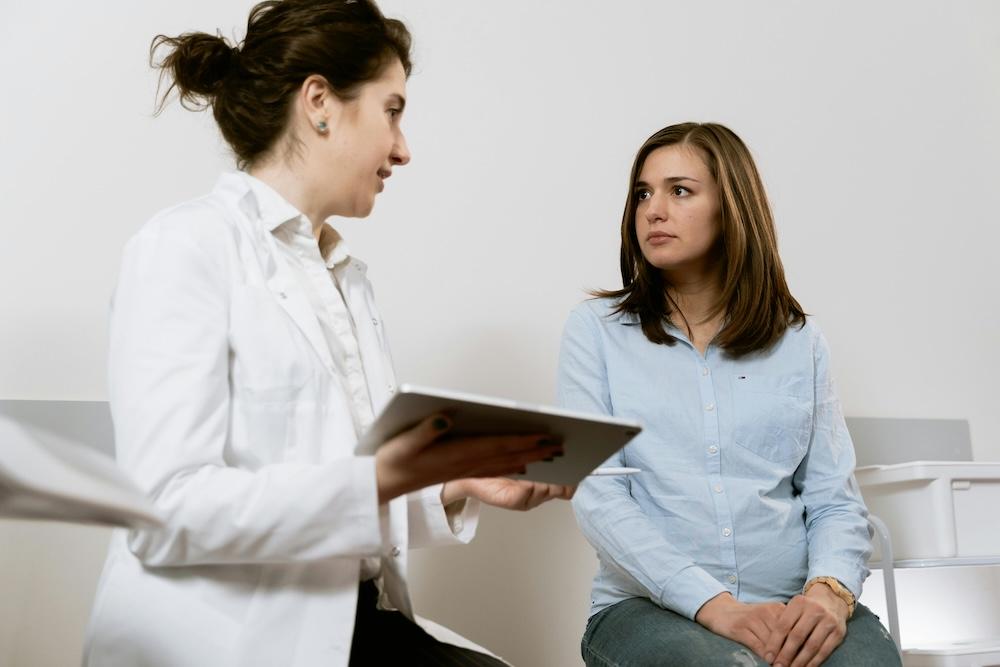 A clinician using a tablet during a patient consultation