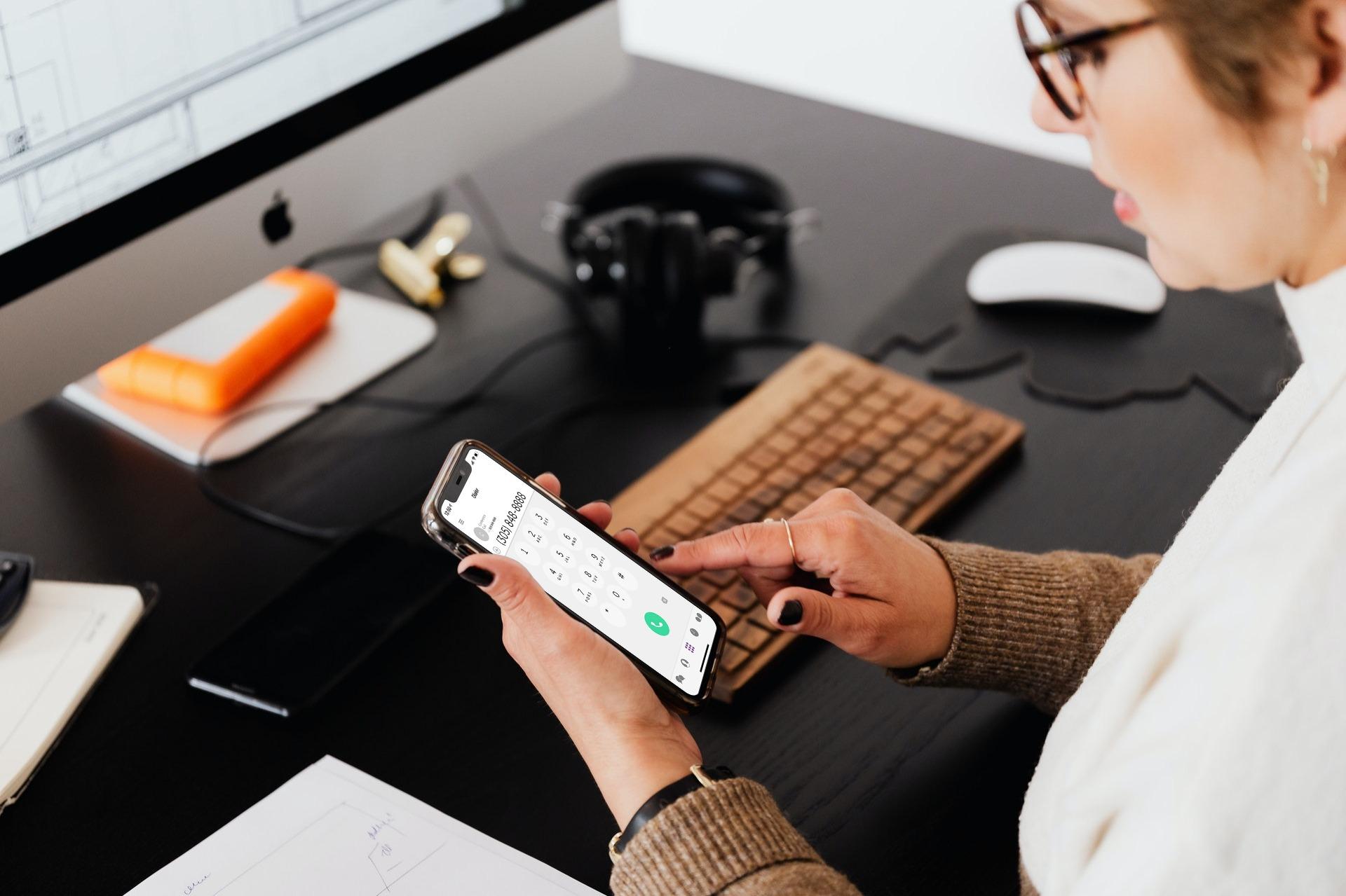 A person using a mobile calling app at their desk