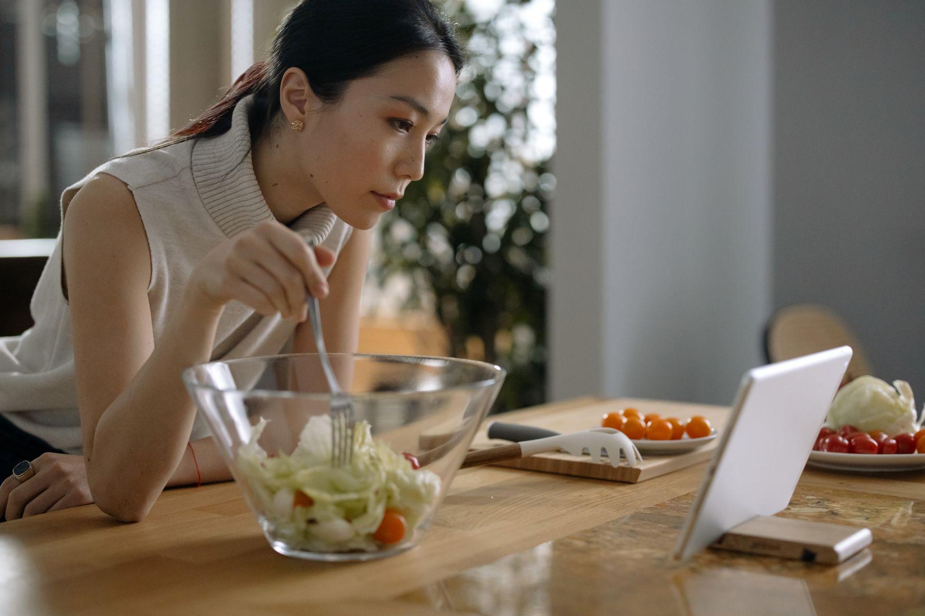 A home cook following a tablet while preparing a meal